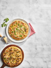 Two Gourmet Pizzas on a Marble Table