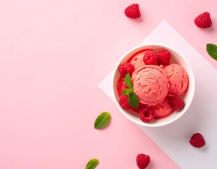 Top View of Pink Raspberry Sorbet Scoops in a White Bowl with Fresh Mint Leaves