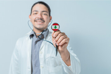 Smiling doctor showing stethoscope with Lebanon flag. Lebanon national healthcare