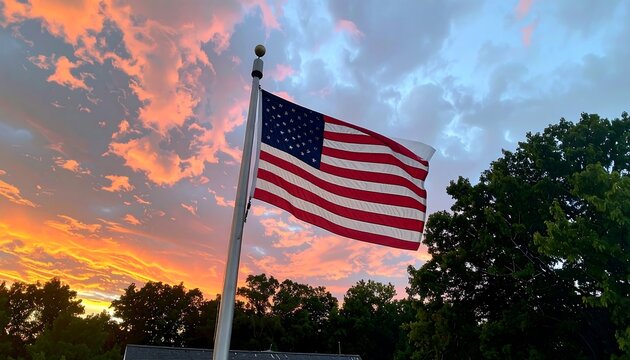 American flag waving in sunset sky