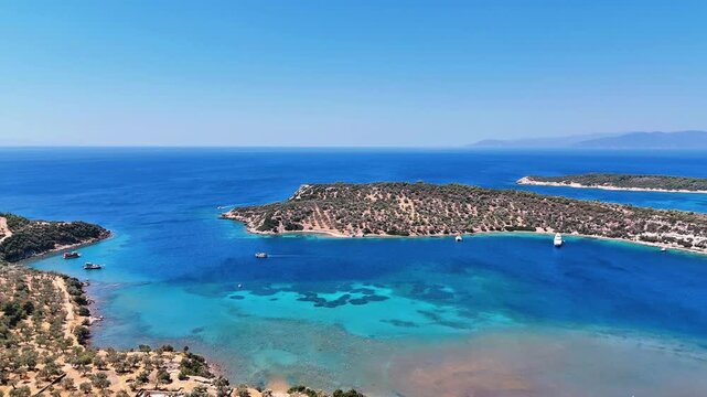 4k drone video of Garip and Kalem islands with turquoise sea and coral reefs in Bademli. Dikili, a district of Izmir famous for its turquoise sea in Turkiye.