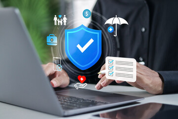 Online insurance service concept, healthcare, home, car, travel, business, comprehensive coverage, and policy management. Businessman using laptop selecting insurance service on website.