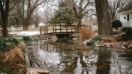 Fototapeta premium Serene winter scene, small wooden bridge over a frozen stream