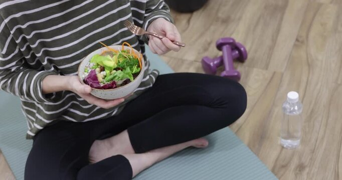 Fresh, nutritious salad held in a person's hands. A balanced meal for a healthy and mindful lifestyle.