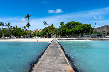 view of Waikiki Beach, Honolulu, Hawaii, with vibrant sunset skies, turquoise waters, and beachfront hotels. Perfect for travel, vacation, tourism, and real estate 