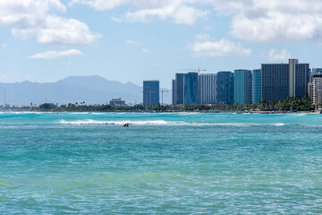 view of Waikiki Beach, Honolulu, Hawaii, with vibrant sunset skies, turquoise waters, and beachfront hotels. Perfect for travel, vacation, tourism, and real estate 