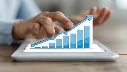 Close-up of hands touching a tablet displaying a growing bar graph