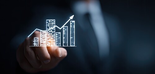 Businessperson's hand points to a glowing bar graph, symbolizing growth and success
