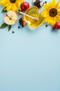 Rosh Hashanah vertical symbols including honey, apples, and pomegranate, framed by bright sunflowers