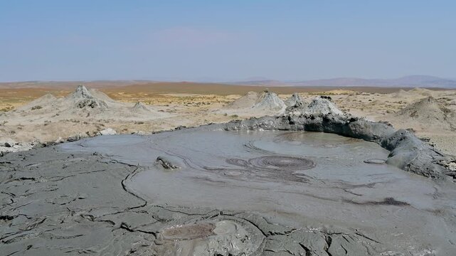 View of a mud volcano bubbling mud in the desert in Qobustan, Azerbaijan