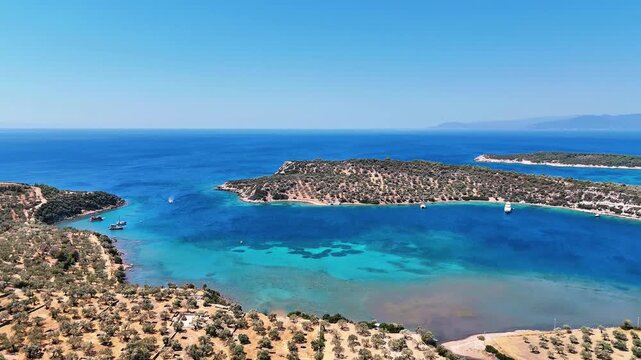 4k drone video of Garip and Kalem islands with turquoise sea and coral reefs in Bademli. Dikili, a district of Izmir famous for its turquoise sea in Turkiye.