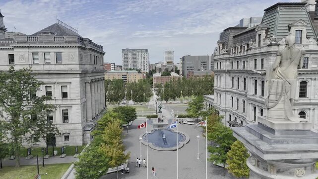 Drone flies up and away from Vauquelin Place along Jacques Cartier Street to the Old Port on sunny morning in Montreal, Quebec, Canada