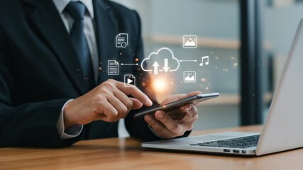 Businessman using smartphone with cloud computing and laptop on desk for data management task - Powered by Adobe