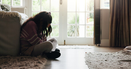 Sad, child and crying on floor in home with mental health, abuse or anxiety from trauma. Crisis, unhappy and girl kid with depression from loneliness, bullying victim or emotional burnout from stress
