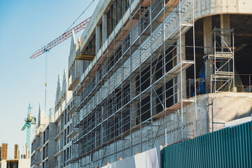 Construction site with scaffolding on a building under renovation in a busy urban area during daylight