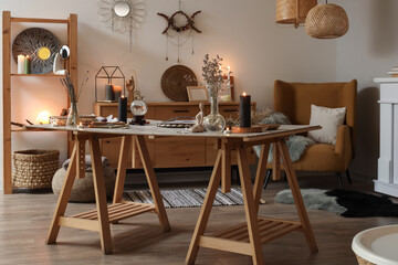 Burning candles with magic attributes on table in witch's room