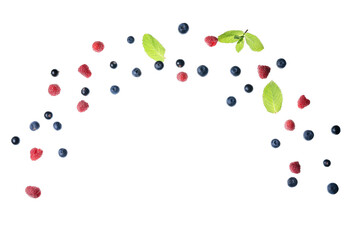 Flying different fresh berries with mint on white background