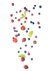Flying different fresh berries with mint on white background