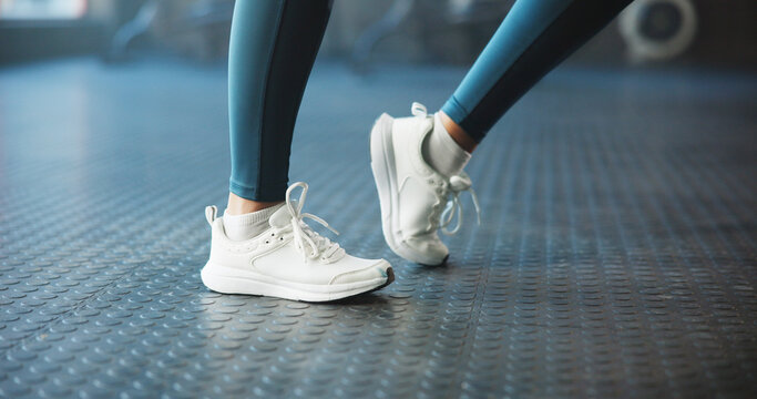 Warm up, shoes and woman in gym, fitness and joint movement with training, wellness and routine. Closeup, sneakers and person in health club, stretching and workout with challenge and exercise