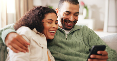 Fototapeta premium Home, laugh and couple with phone on sofa for social media, online message and connection. Relax, weekend and man with woman on smartphone for reading news, notification and bonding in living room