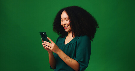 Studio, excited and woman with smartphone, good news and notification for job opportunity or online. Reading, email and happy person with tech, green background and chat on social media and space