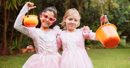 Bucket, halloween and portrait of girls outdoor together for celebration, fantasy or holiday. Bonding, candy and hugging with smile of children friends in neighborhood for trick or treat tradition