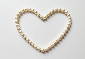 Pearl Necklace Forming Heart Shape on White Background