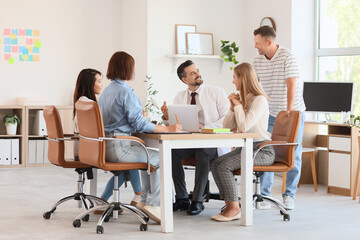 Obraz premium Group of teachers working at table in school office