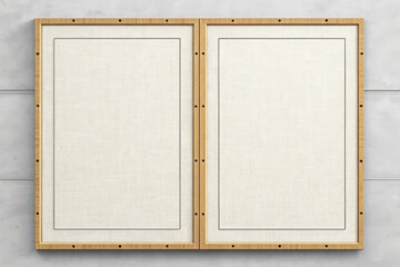 Fototapeta premium Two framed panels displaying textured ivory surfaces adorn a grey textured wall together