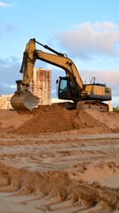 Obraz premium Excavator Digging at Urban Construction Site