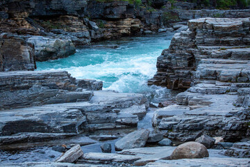 The turquoise water of the beautiful Abisko River, Abiskojokk, flowing between the rocks at Abisko Canyon, Sweden, Northern Europe