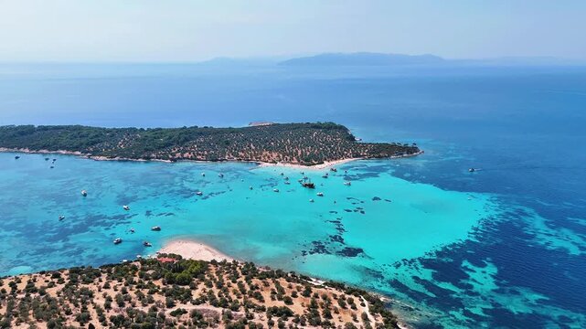 4k drone video of Garip and Kalem islands with turquoise sea and coral reefs in Bademli. Dikili, a district of Izmir famous for its turquoise sea in Turkiye.