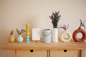 Decorative vases and plants arranged on a wooden table