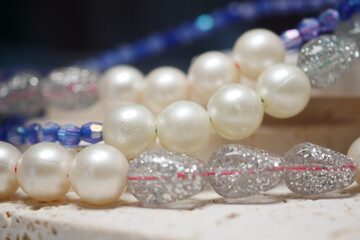 Beaded necklaces displayed on a surface at a craft fair