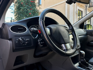 The image features a modern car dashboard with a stylish steering wheel and userfriendly controls, enhancing the driving experience for everyone and making each journey more enjoyable