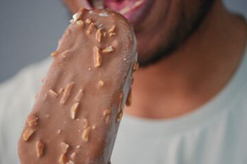 Enjoying a chocolate coated ice cream bar on a warm day