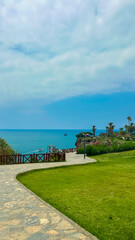 Experience a breathtaking coastal view that features lush greenery, alongside a serene waterscape where the ocean meets the horizon, creating the perfect backdrop for relaxation and exploration