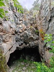 Mysterious Cave Entrance Amidst Rocky Terrain A Geological Wonder and Natural Hideaway