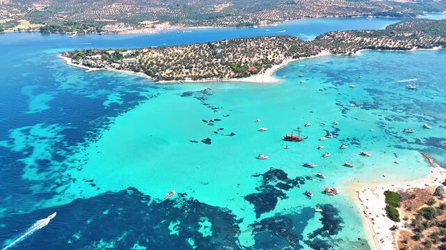 4k drone video of Garip and Kalem islands with turquoise sea and coral reefs in Bademli. Dikili, a district of Izmir famous for its turquoise sea in Turkiye.