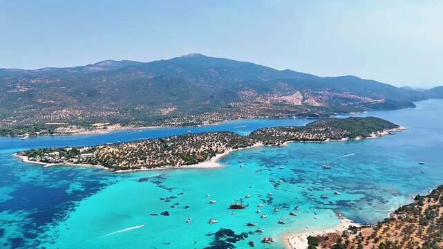 4k drone video of Garip and Kalem islands with turquoise sea and coral reefs in Bademli. Dikili, a district of Izmir famous for its turquoise sea in Turkiye.