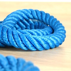 Twisted blue rope on light wood