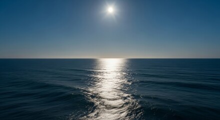 Fototapeta premium Silvery moonlight across sea expanse, ocean water surface with reflection, night casting blue toward horizon line