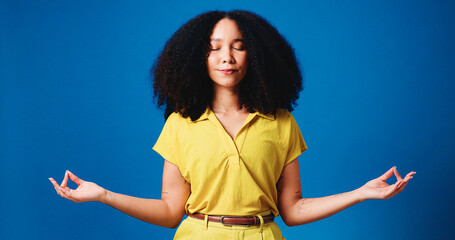 Eyes closed, lotus pose and woman in studio, meditation and chakra with wellness on blue...