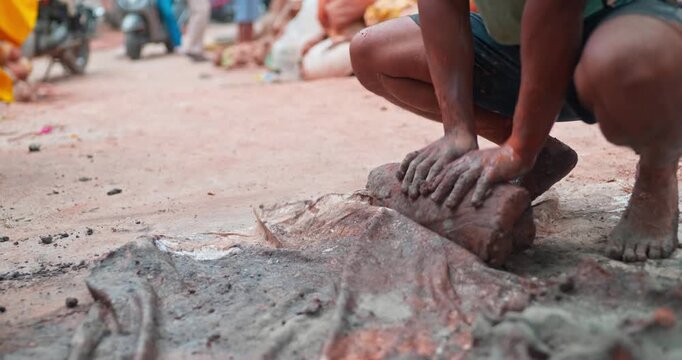 Indian Clay Artist: Preparing Clay with Feet for Ganesh Idol Making