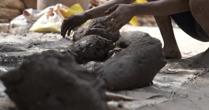 Indian Clay Artist: Preparing Clay with Feet for Ganesh Idol Making