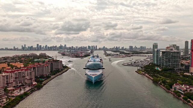 Aerial view of luxury liner voyage. Ship leaving Miami beach port. Miami tour. Cruise ship voyage. Aerial view of cruise in summer vacation. Cruise ship tour and travel at sea. Luxury cruise voyage