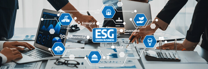 This image illustrates a collaborative team effort in developing an ESG framework for sustainable business practices, emphasizing digital tools and strategic planning. Amity
