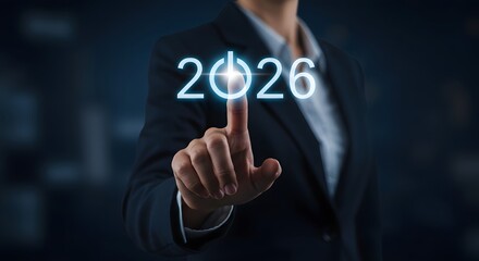 Businesswoman activating 2026 with finger on power button