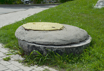 sewer manhole on the lawn installed with violations