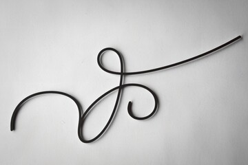 A photo of a white background with a curved, black decorative line